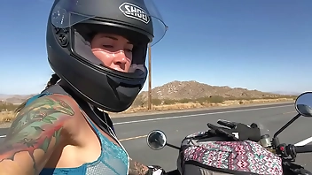 felicity feline riding on aprilia tuono motorcycle