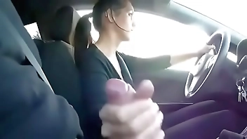 Girl driving a cock while driving in a car