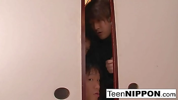 Japanese girl plays with her pussy while some boys peep
