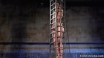 Babe in cage gets water bondage