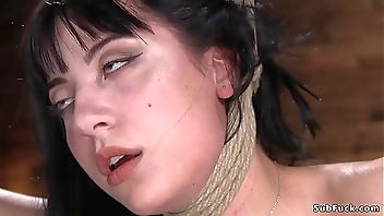 Brunette hogtied in a hip suspension